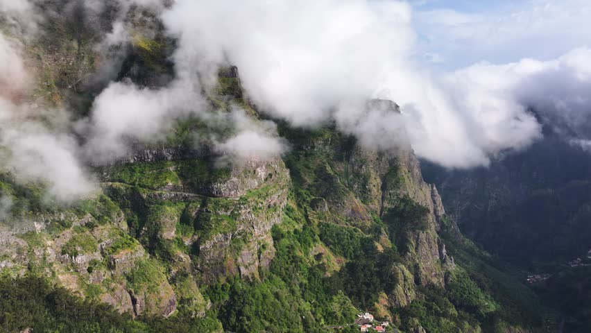 Curral das Freiras dramatic mountainside surrounded by eerie mountain fog, drone
