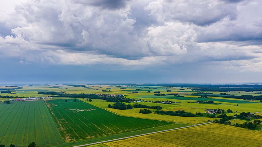 Panorama Of Agricultural Fields With Overcast Sky Filled With Clouds. Timelapse