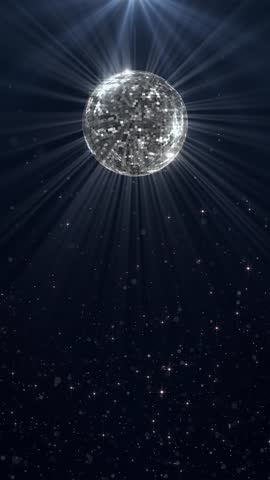 
Disco Ball with Reflected Moving Rays Rotating. Mirror disco ball in white light. Isolated disco ball on black background. Close-up. Mirror ball spinning indoors. Performance. The reflection of light