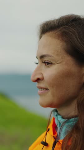 Contemplative Moment: A Profile of a Woman in Nature Embracing Her Surroundings with Serenity While Dressed in Bright Outdoor Gear
