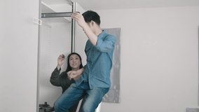 A man accurately measures and assembles furniture as a woman observes, showcasing teamwork in home improvement. This scene highlights the importance of precision and collaboration in DIY projects. - Powered by Shutterstock - Get 15% off with code: PIKWIZARD15