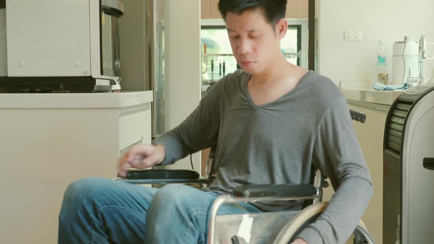 A casual portrait of a man sitting comfortably in a stylish, modern home setting. The atmosphere reflects a sense of relaxation and contemporary design.