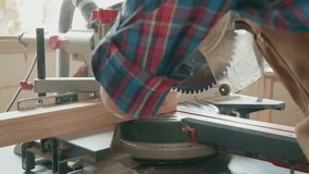 A skilled craftsman works with a power saw, shaping a wooden piece. The image captures the intricate process of woodworking, showcasing the tools and craftsmanship involved in creating fine wood produ - Powered by Shutterstock - Get 15% off with code: PIKWIZARD15