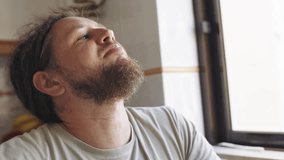 Thoughtful man with dreadlocks eating meal by the window - Powered by Shutterstock - Get 15% off with code: PIKWIZARD15