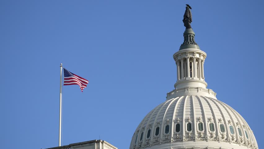 Capitol dome closeup with American flag. Washington DC iconic landmark. USA Congress building detail shot. Capitol architecture and flag. Political symbol of democracy.