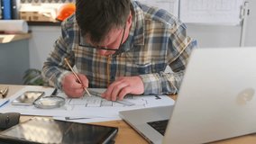 architect carefully sketches blueprints, focused architect drawing precise blueprints carefully, dedicated architect attentively sketches meticulous blueprints using measurement tools at tidy - Powered by Shutterstock - Get 15% off with code: PIKWIZARD15