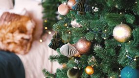 Decorated pine tree with gold baubles and fairy lights against soft background - Powered by Shutterstock - Get 15% off with code: PIKWIZARD15