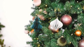 Close up of a decorated green pine tree with shiny round ornaments and warm lights - Powered by Shutterstock - Get 15% off with code: PIKWIZARD15