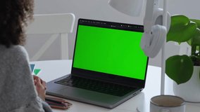 Primary school Student African American child with headphones using laptop green screen chroma key. Distance learning online education. Schoolboy girl studying at home with digital tablet computer and - Powered by Shutterstock - Get 15% off with code: PIKWIZARD15