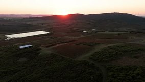 An aerial view of sunrise illuminating the farmlands and gentle hills of Piriapolis, Uruguay, capturing the peaceful beauty of the countryside at dawn - Powered by Shutterstock - Get 15% off with code: PIKWIZARD15