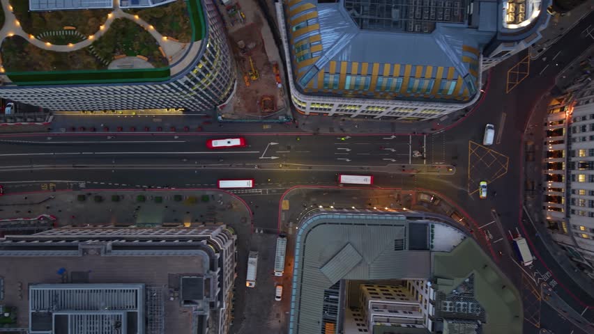 Aerial top down view of the illuminated streets at the City of London, England, during morning with car and pedestrian traffic of commuters