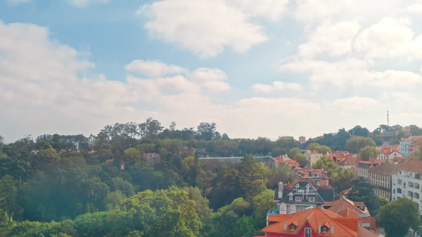 Inspired historic center Sintra Portugal with colorful houses red rooftops palace towers lush forest hills under warm sunny weather UNESCO heritage architecture cultural legacy travel tourism top view