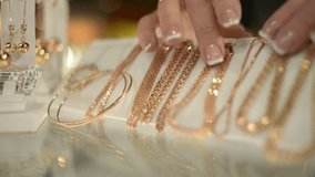 A jewelry seller displays gold earrings, rings, bracelets, and chains at a market stall, highlighting craftsmanship, luxury items, and traditional jewelry trade. - Powered by Shutterstock - Get 15% off with code: PIKWIZARD15