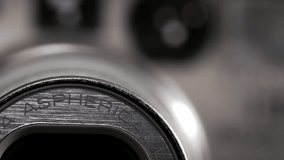 Macro rack focus on silver 35mm point and shoot lens as zoom moves - Powered by Shutterstock - Get 15% off with code: PIKWIZARD15