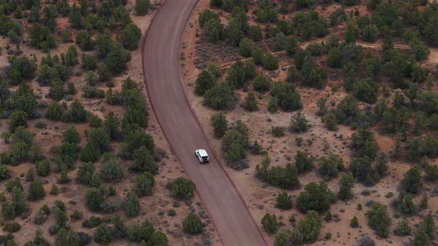 Car on Winding Dirt Trail Aerial View