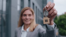 Close up smiling Caucasian middle-aged business woman holding key from new office home house investment businesswoman happy female realtor seller hold bunch keys mortgage insurance dwelling in city - Powered by Shutterstock - Get 15% off with code: PIKWIZARD15