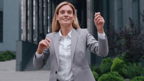 Happy crazy funny adult Caucasian business woman dancing jumping in city businesswoman having fun fooling around in downtown celebrating job success female rejoice victory celebrate joyful jump dance - Powered by Shutterstock - Get 15% off with code: PIKWIZARD15