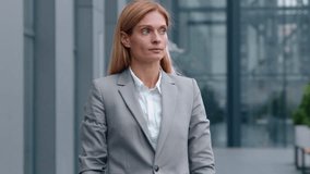 Serious Caucasian middle-aged business woman checking time with wristwatch in city looking around waiting meeting adult businesswoman female worker executive entrepreneur check clock lateness problem - Powered by Shutterstock - Get 15% off with code: PIKWIZARD15