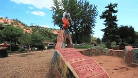 A slow-motion footage of caucasian male parkour freerunning flips in a park - Powered by Shutterstock - Get 15% off with code: PIKWIZARD15