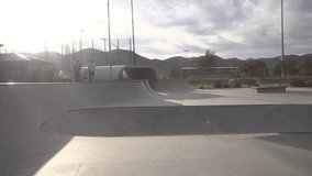 A slow motion footage of a young man doing stunts with his bike at skate park on a sunny day - Powered by Shutterstock - Get 15% off with code: PIKWIZARD15