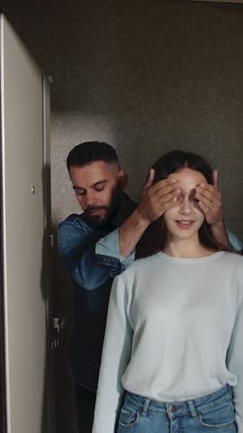 Two people share a fun surprise moment in their new flat apartment