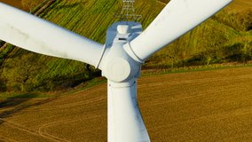 Spinning wind turbine blades generating green renewable energy on wind farm. Wind turbine moving broad blades to generate renewable energy. Moving rotor blades creating renewable output on wind farm - Powered by Shutterstock - Get 15% off with code: PIKWIZARD15