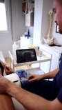 Professional physiotherapist conducting a diagnostic ultrasound examination on a patient's leg, analyzing the real time sonogram on a digital tablet to assess muscle and tissue condition - Powered by Shutterstock - Get 15% off with code: PIKWIZARD15