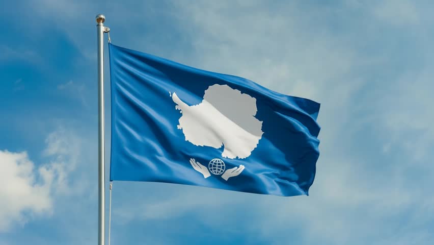 flag waving in the wind against a cloudy blue sky on a bright sunny day