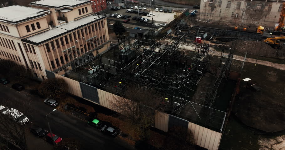 Industrial electrical substation of Budapest on a cold, overcast day. Dark monotone mood with power lines, transformers, and urban infrastructure in gloomy Eastern Europe weather.