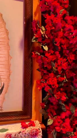 Virgin of Guadalupe image with candle, serene, religious tranquility