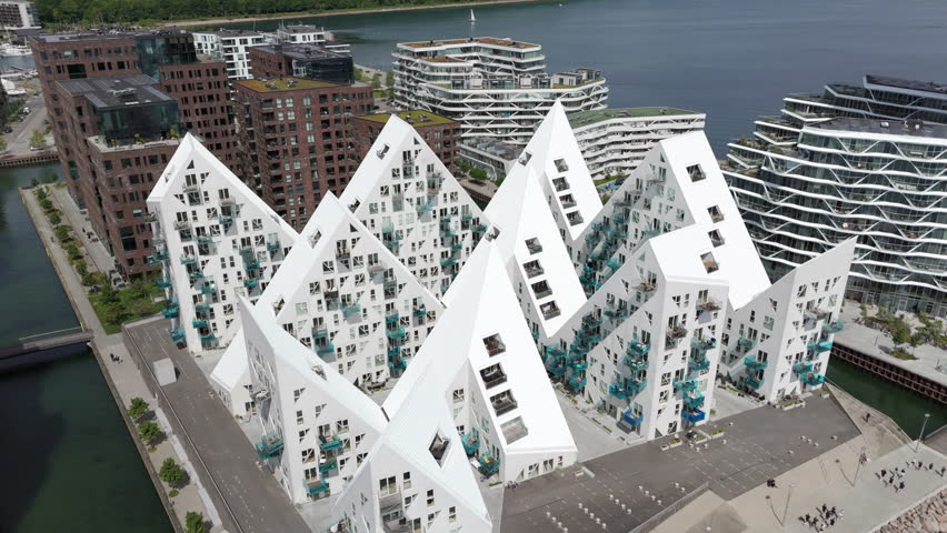Aerial orbiting shot of modern residential buildings in the Aarhus Docklands neighbourhood on a sunny day in Aarhus, Denmark.
