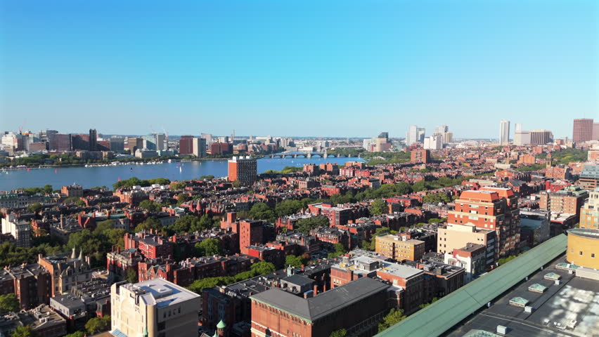 High angle shot showing Back Bay East neighborhood and Charles River under clear blue sky.