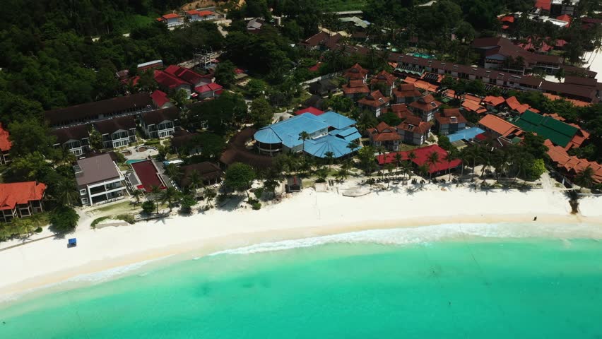 Aerial view of Long Beach and resorts with clear turquoise waters and tourists on Redang Island. Malaysia