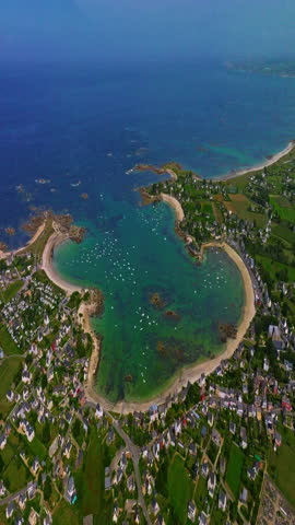  Aerial view of amazing rocky coast of the atlantic ocean in France at sunset. Establishing shot of Bretagne. Drone flying up above the rocks with waves crashing on them in North Brittany