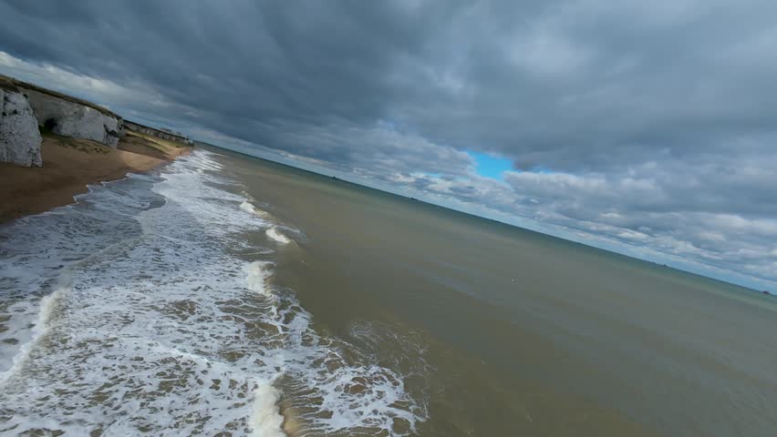 FPV drone video featuring a low, fast flight over the waves of the English Channel, emphasizing the dynamic movement, sea environment, and extreme video style.