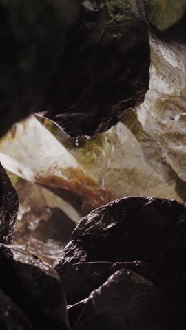 Vertical Video: Backlit Sea Cave Splash on Rocks