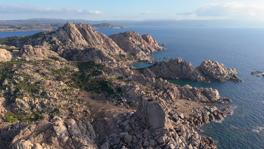 italian coast scenery, golden hour illuminates serene landscape featuring cliffs and tranquil waters. Sardinia