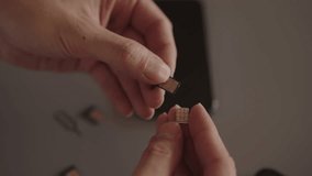 Person holding mobile phone, inserting two sim card into smartphone side tray, setting up new communication services and connectivity. Concept of telecom, repair, device management, slow motion. - Powered by Shutterstock - Get 15% off with code: PIKWIZARD15