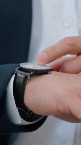 Closeup Asian Korean business man looking with wristwatch clock checking time in city Chinese Japanese middle-aged businessman boss company CEO agent check lateness waiting for corporate meeting taxi
