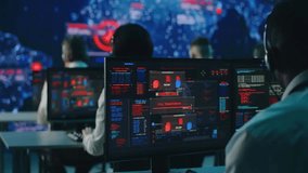 Anonymous professionals work at desks entering security codes on computers during a global digital virus attack, illustrating cybersecurity, IT defense, and tech crisis management. - Powered by Shutterstock - Get 15% off with code: PIKWIZARD15