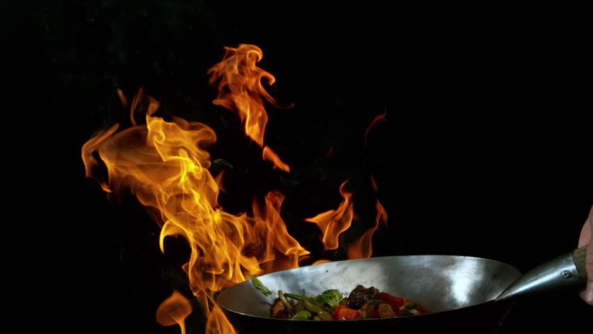 Super Slow Motion of Flying Asian Meal with Vegetable and Prawns into Wok Pan. Camera Placed on High Speed Cine Bot. Filmed on High Speed Cinema Camera, 1000 fps