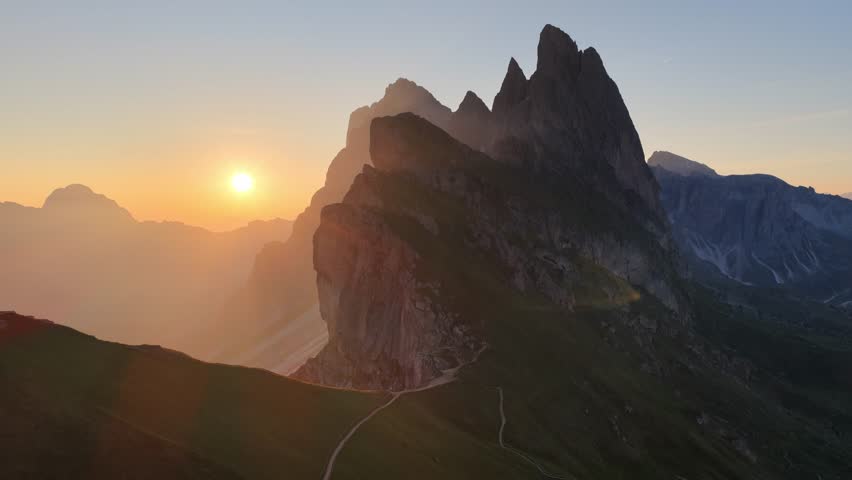 drone shot of sunrise on Seceda in the Dolomites, an iconic mountain in Dolomites, Italy, the Italian picturesque Pues Odle nature park in the Dolomite mountains. 