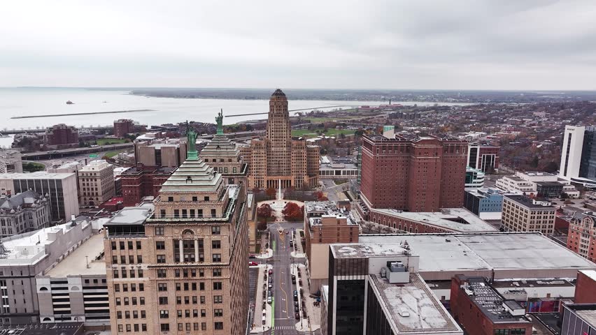 Aerial drone panorama of downtown Buffalo, New York, showcasing the city’s skyline, major high-rise buildings, Buffalo City Hall, and the Liberty Building with its rooftop Statues of Liberty. The view
