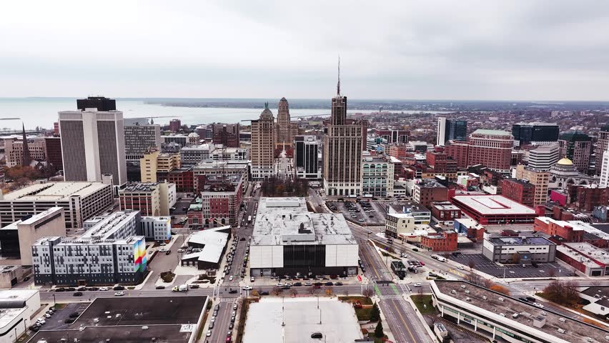 Aerial drone panorama of downtown Buffalo, New York, showcasing the city’s skyline, major high-rise buildings, Buffalo City Hall, and the Liberty Building with its rooftop Statues of Liberty. The view