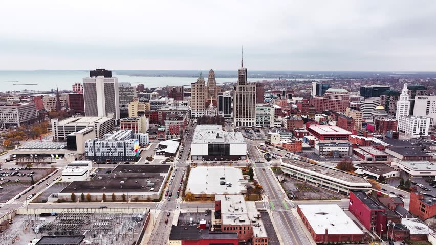 Aerial drone panorama of downtown Buffalo, New York, showcasing the city’s skyline, major high-rise buildings, Buffalo City Hall, and the Liberty Building with its rooftop Statues of Liberty. The view