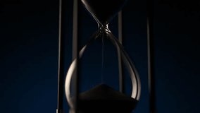 macro shot of sand flowing inside a transparent hourglass, illustrating balance, decay, and the eternal rhythm of time - Powered by Shutterstock - Get 15% off with code: PIKWIZARD15