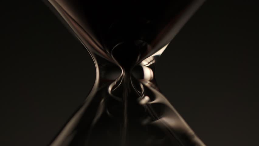 macro shot of sand flowing through the narrow neck of an hourglass, symbolizing time passing, balance, and the delicate rhythm of each second.