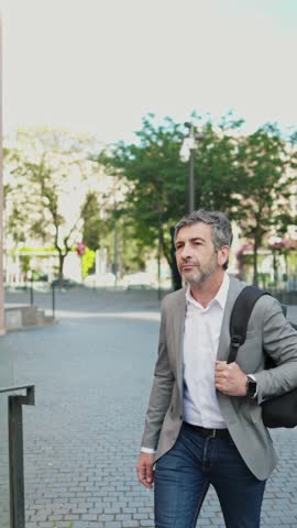 Businessman walking and talking on phone