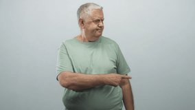 Man points finger to right with pursed lips and slight frown wearing green t shirt in studio; disapproval direction. - Powered by Shutterstock - Get 15% off with code: PIKWIZARD15