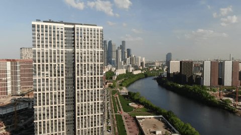 Drone Flight over Riverbank Tall Residential Architecture